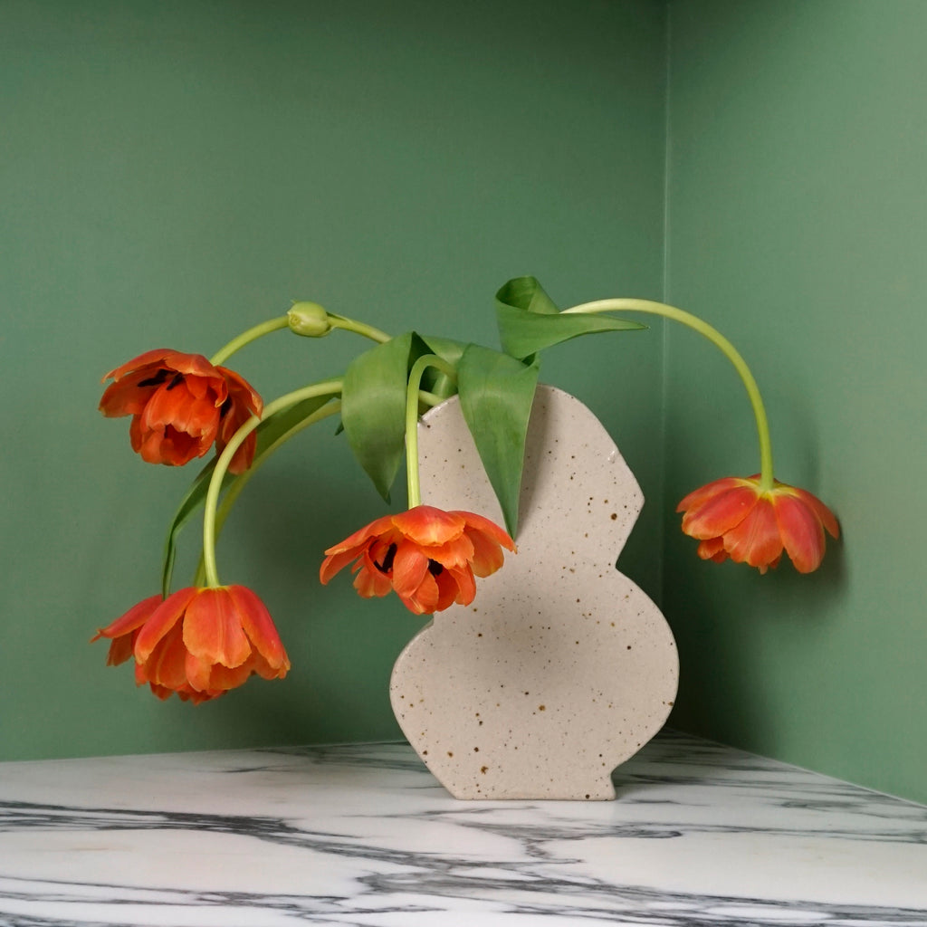 drooping red tulips in a weirdo handmade vase by mae ceramics.