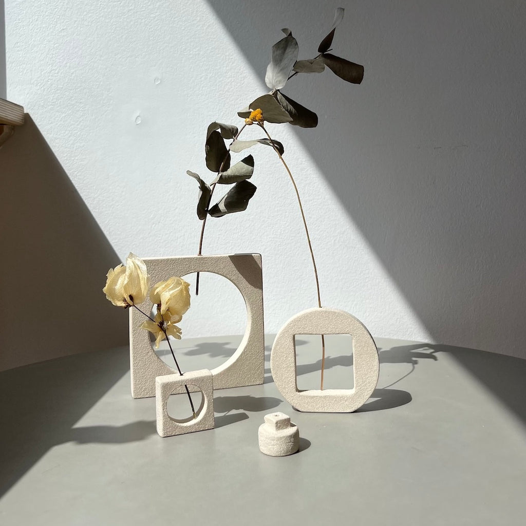 an interchangeable vase and incense holder that can be broken into separate pieces or assembled as one.