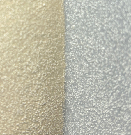 close up detail of sand clay and a denim blue glaze.