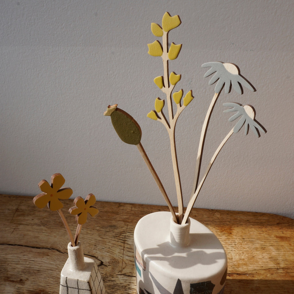 hand painted plywood flowers in two bud vases. 
