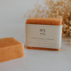 Bar of soap with 'WS + Co' branding on a white surface with dried flowers in the background | Wild Sage & Co | Shop Fodder