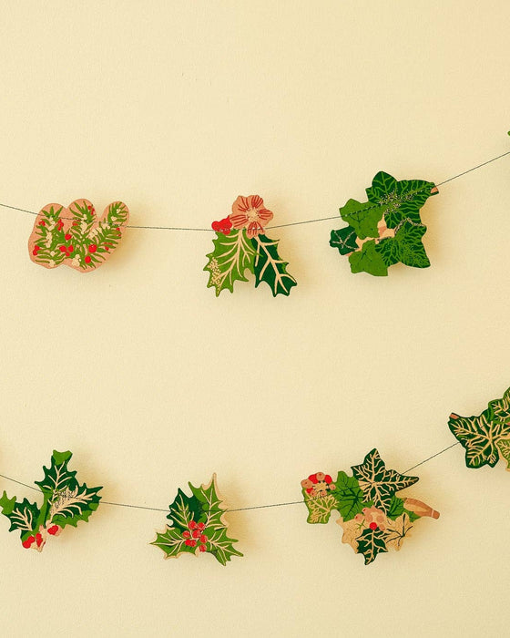 Decorative holly berry garland on a beige background