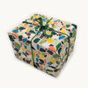 Gift box wrapped in colorful terrazzo patterned paper with green string on a white background.  | Hadley Paper Goods | Shop Fodder