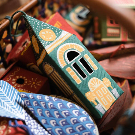 Decorative house-shaped box with intricate design on a colorful background. East End Press | Shop Fodder