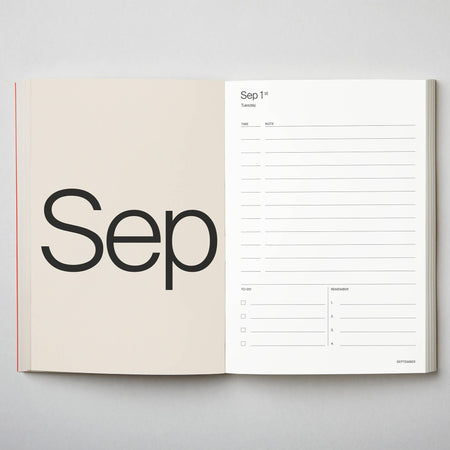 Open planner showing September layout on a grey background. 2026 Diary Red | Kinshipped |Shop Fodder