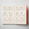 Calendar with '2027' printed on a beige background. 2026 Planner | Kinshipped | Shop Fodder