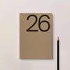 Brown notebook with the number 26 on a light gray background. Diary 2026 Planner | Kinshipped | Shop Fodder