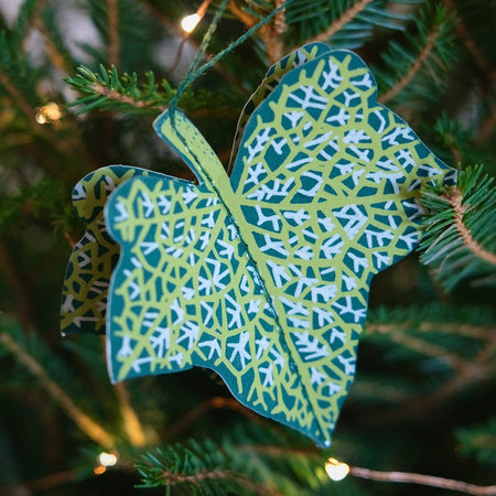 Decorative leaf ornament with intricate pattern hanging on a Christmas tree. East End Press | Shop Fodder