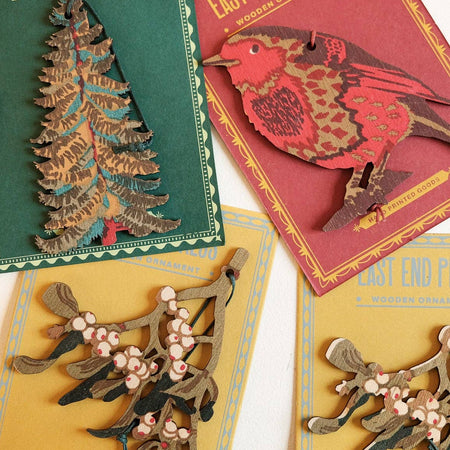 Collection of East End Press wooden ornaments on display 