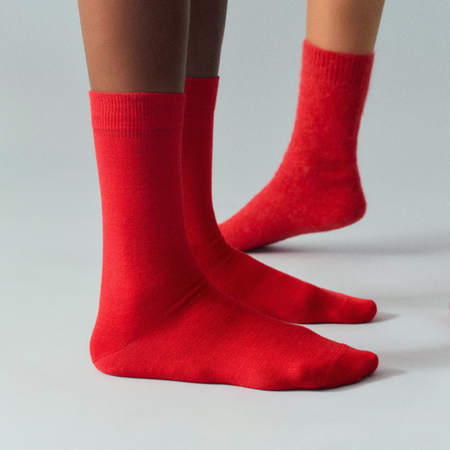 Red socks worn by a person on a gray background. Pairs Socks | Shop Fodder