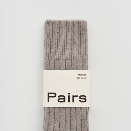 Gray sock with 'Pairs' label on a light gray background. Pairs Socks | Shop Fodder