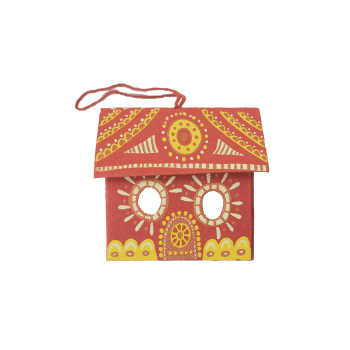 Decorative red birdhouse with yellow and white patterns on a white background. East End Press | Shop Fodder