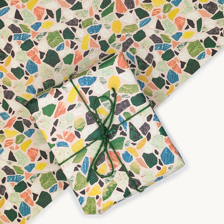 Colorful terrazzo-patterned paper with a tied green string on a white background.  | Hadley Paper Goods | Shop Fodder