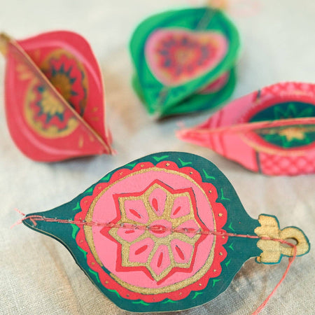 Decorative colorful Diwali oil lamps on a light fabric background. East End Press | Shop Fodder