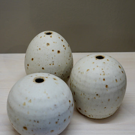 Three ceramic pots with speckled glaze on a white surface. Aku Ceramics | Shop Fodder
