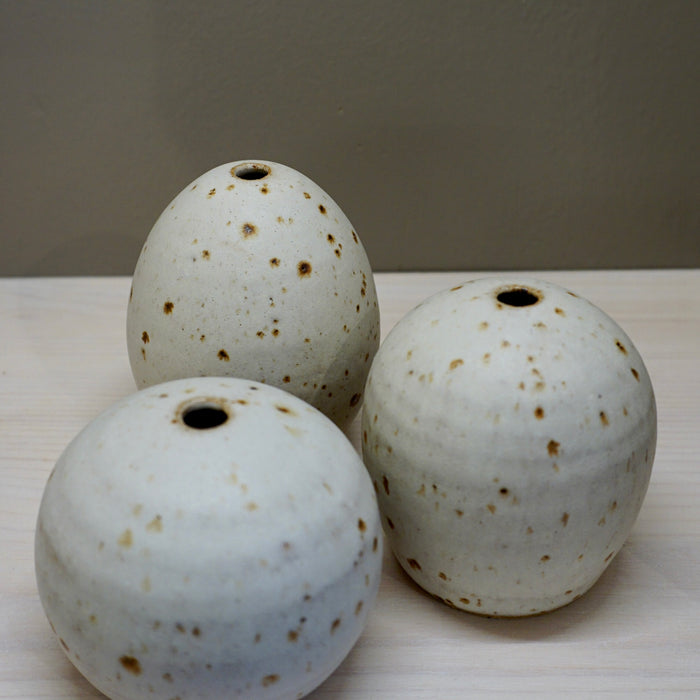 Three ceramic pots with speckled glaze on a white surface. Aku Ceramics | Shop Fodder