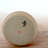 bottom of a handmade porcelain slipcast vase with the makers mark of Anna Jones Ceramics. 