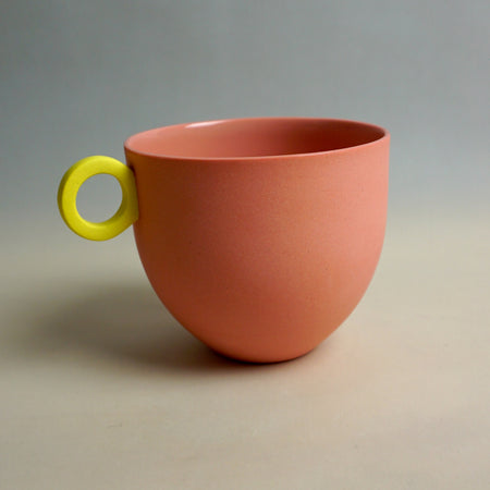 Pink cup with a yellow handle on a gray background. Syros Mug | Anna Jones Ceramics | Shop Fodder