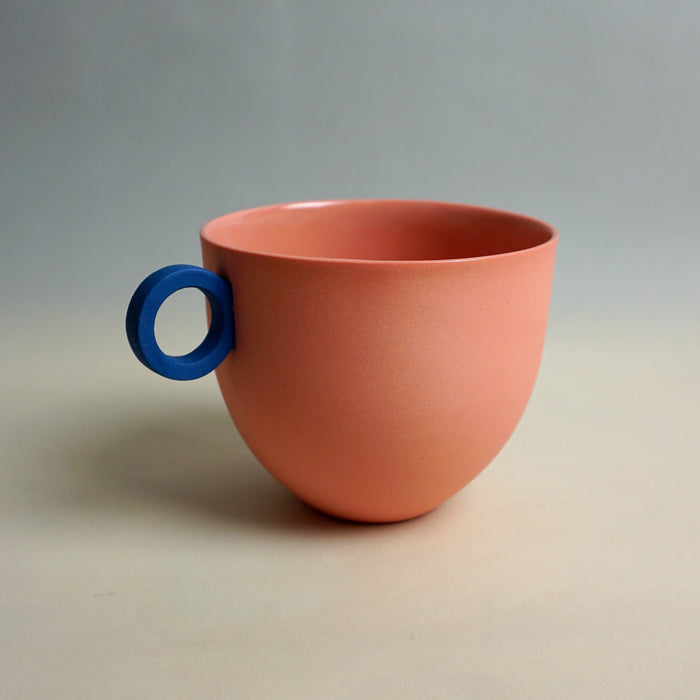 Ceramic cup with a blue handle on a neutral background. Syros Mug | Anna Jones Ceramics | Shop Fodder