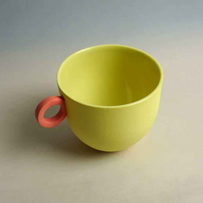 Yellow mug with a red handle on a neutral background. Syros Mug | Anna Jones Ceramics | Shop Fodder