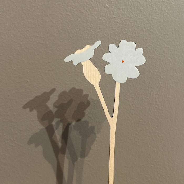 Decorative flower stick with white flowers on a plain background. Anna Wiscombe | Shop Fodder