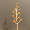 Decorative plant stem with brown leaves against a gray background. Anna Wiscombe | Shop Fodder