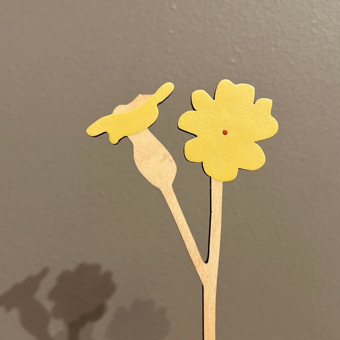 Two yellow paper flowers on a gray background. Anna Wiscombe | Shop Fodder