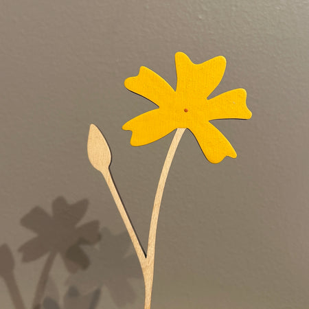 Yellow paper flower on a brown background. Anna Wiscombe | Shop Fodder
