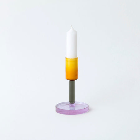 Coloured glass a candlestick holder on white background. 