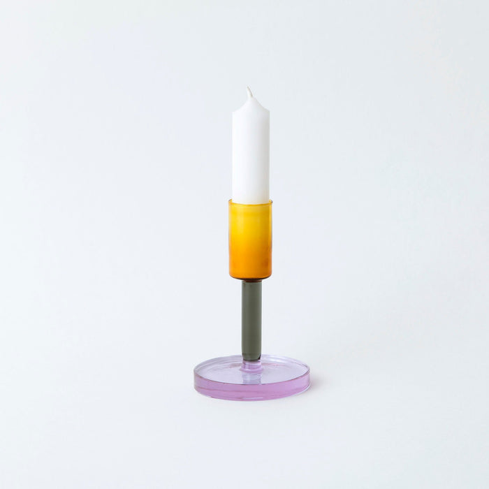 Coloured glass a candlestick holder on white background. 