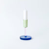 Coloured glass candlestick holder on white background
