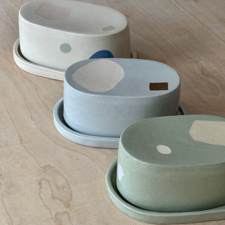 Three ceramic butter dish with abstract designs on a wooden surface. Inlay Butter Dish | Brutes Ceramics | Shop Fodder