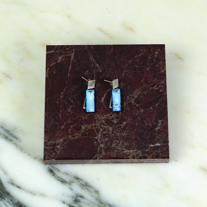 Pair of earrings on a dark brown marble card with a marble background. Scarlett Cohen French | Shop Fodder