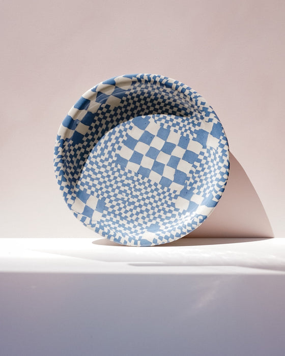 Blue and white checkered platter on a light pink background. Fern Taylor Ceramics. Fodder
