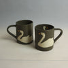 Two brown mugs with white swan designs on a light grey background | Fern Taylor Ceramic Nerikomi Vase | Shop Fodder