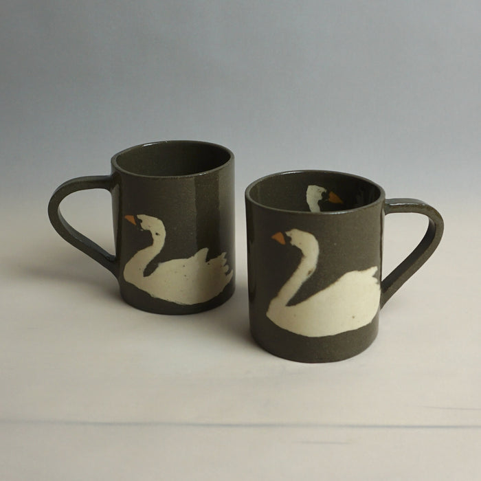 Two brown mugs with white swan designs on a light grey background | Fern Taylor Ceramic Nerikomi Vase | Shop Fodder