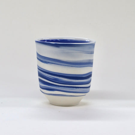 Ceramic cup with blue and white striped pattern on a white background | Janne Meijer | Shop Fodder