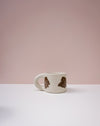 White mug with brown abstract designs on a light pink background. Portrait Mug | Brutes London | Handmade Ceramics | Fodder