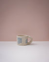 Ceramic mug with blue geometric design on a pink background. Portrait Mug | Brutes London | Handmade Ceramics | Fodder