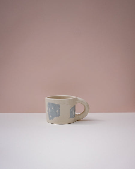 Ceramic mug with blue geometric design on a pink background. Portrait Mug | Brutes London | Handmade Ceramics | Fodder