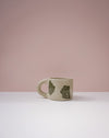 Green ceramic mug with bear designs on a pink background. Portrait Mug | Brutes London | Handmade Ceramics | Fodder
