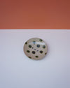 Round ceramic dish with black speckles on a white background. Cara Guthrie Ceramics. Fodder