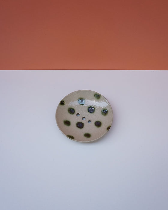 Round ceramic dish with black speckles on a white background. Cara Guthrie Ceramics. Fodder