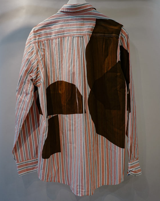 A striped long-sleeve shirt with abstract brown patchwork overlays, displayed on a mannequin against a neutral gray background. Caroline Dickinson Shirt | Fodder