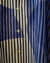 Close-up of a button-front shirt with vertical navy, black, and off-white stripes, overlaid with abstract blue and navy graphic shapes. Caroline Dickinson Shirt | Fodder