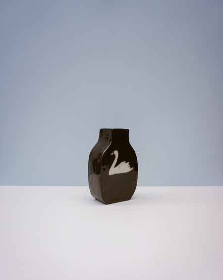 Brown vase with a white swan design on a light gray background. Nerikomi Vase | Fern Taylor | Shop Fodder