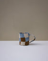 Handbuilt nerikomi check coffee mug by Fern Taylor in layered coloured stoneware. Fodder