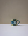 Handbuilt nerikomi check coffee mug by Fern Taylor in layered coloured stoneware. Fodder.