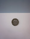 Round black and white checkered object on a light gray background. Fern Taylor | Nerikomi Dish | Shop Fodder