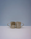 Two ceramic mugs with textured surfaces on a light grey background. Grain Nerikomi Ceramic Mug | Fern Taylor | Kentish Town Stores